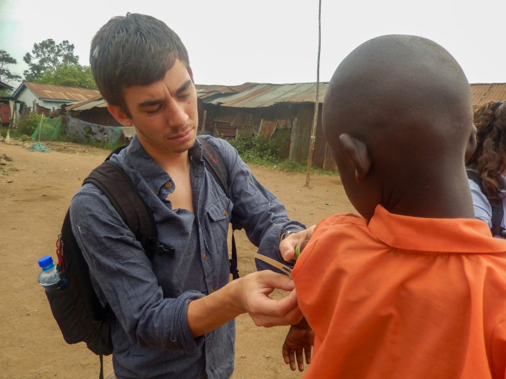 Chris Rios working with a child in Kenya