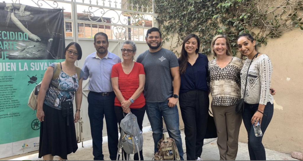 A team from Prevencasa and Families at the Border stand near a facility in Tijuana