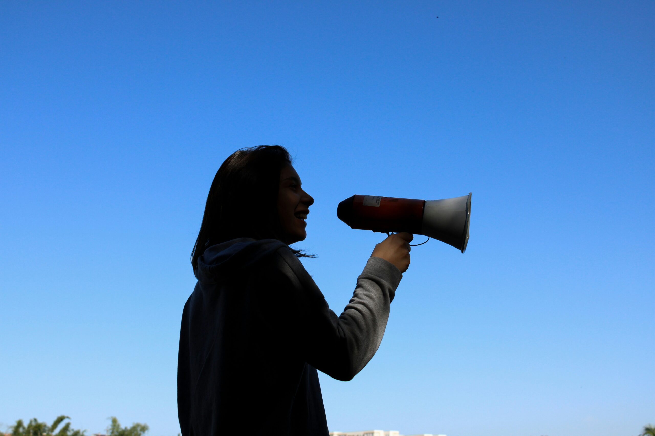 A woman holds a megaphone