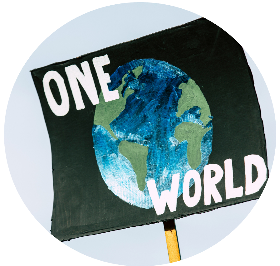 a protest sign says "one world"