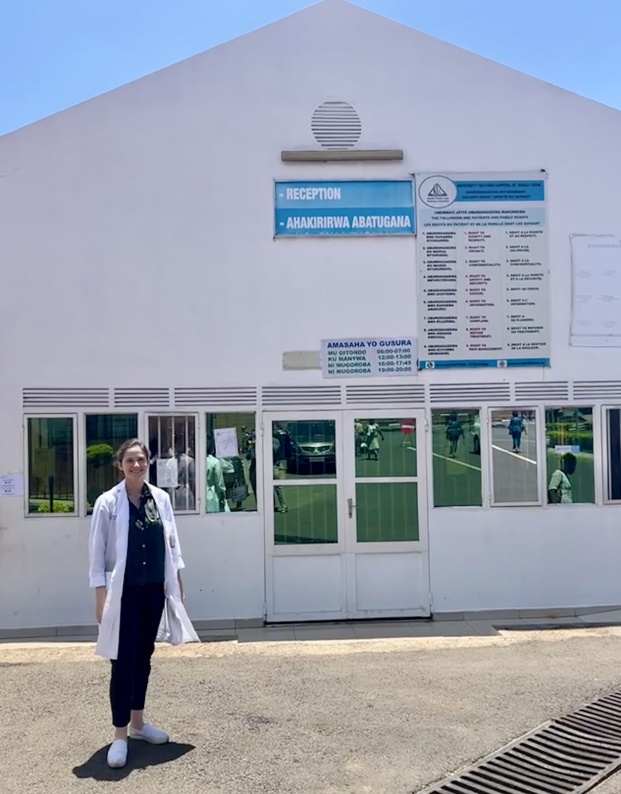 Medical Resident Savannah Karmen-Tuohy outside a hospital Kigali wearing scrubs