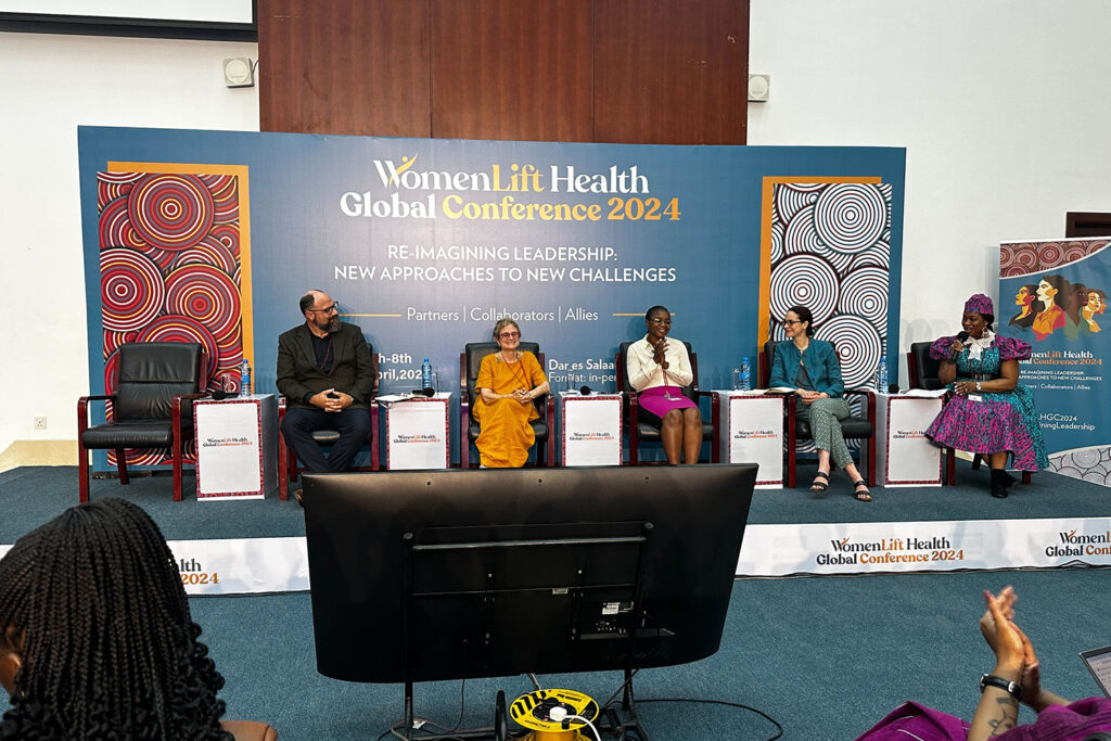 Michele Barry at the WomenLift GLobal Health Conference in 2024 participates in a panel. She is smiling and talking