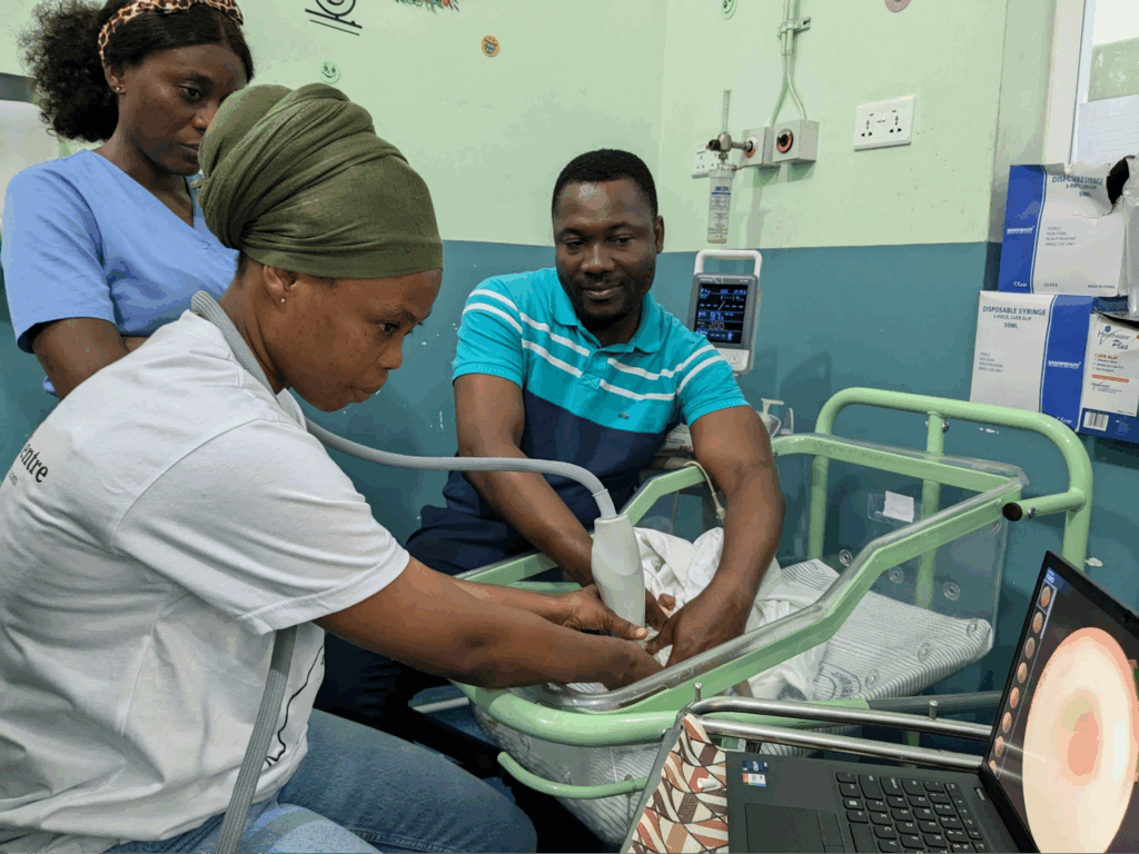 Munira, a community health worker, takes images of a baby's eyes for evaluation for retinopathy of prematurity.