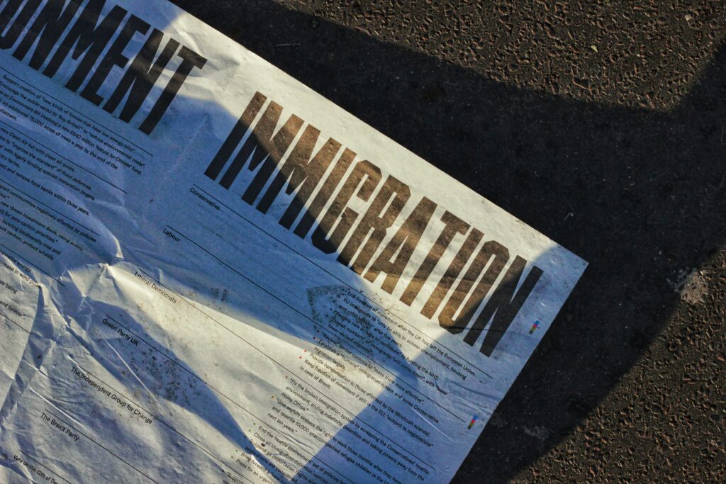 a black and white piece of paper says "immigration"