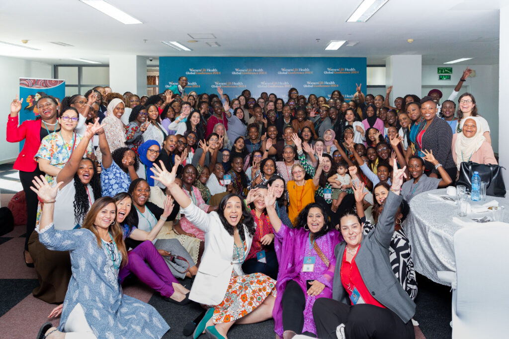 Women leaders gather at a mentorship breakfast at the womenlift global health conference in Tanzania, looking joyful