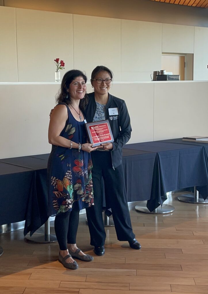 Desiree LaBeaud receives the Outstanding Faculty award at the May 2026 communaty engagement awards