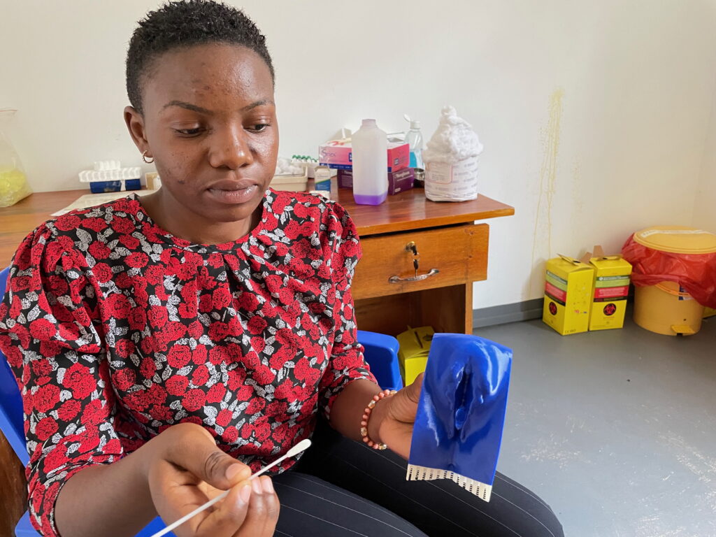 Dr Renatha Nindi, Clinical Officer, a study coordinator, uses a vaginal model to teach women how to test themselves for schistosomiasis.
