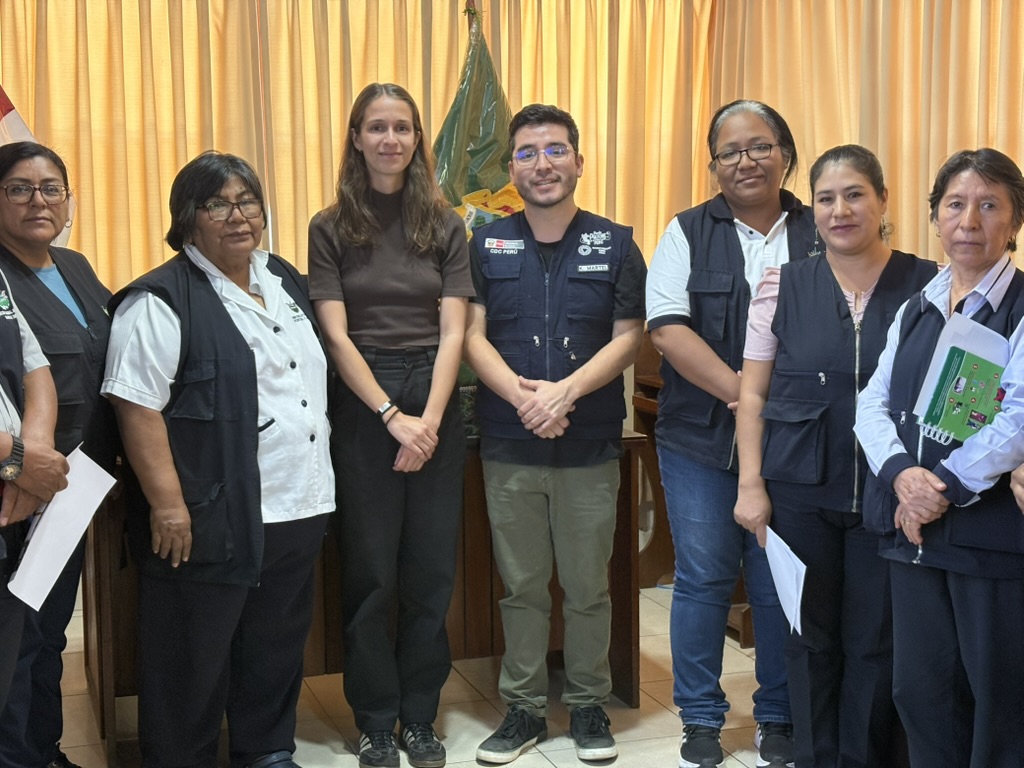 Singleton, third from right, meets with representatives of the Peruvian CDC to share her team's findings. Courtesy of Aly Singleton