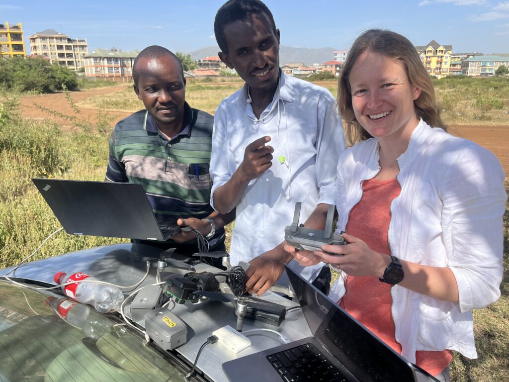Joelle Rosser and collaborators in Kenya prepare a drone for flight to surveil trash